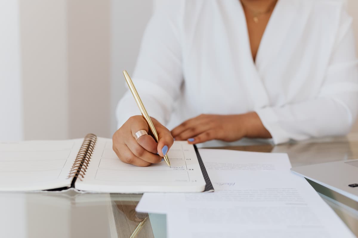 Person writing in a planner
