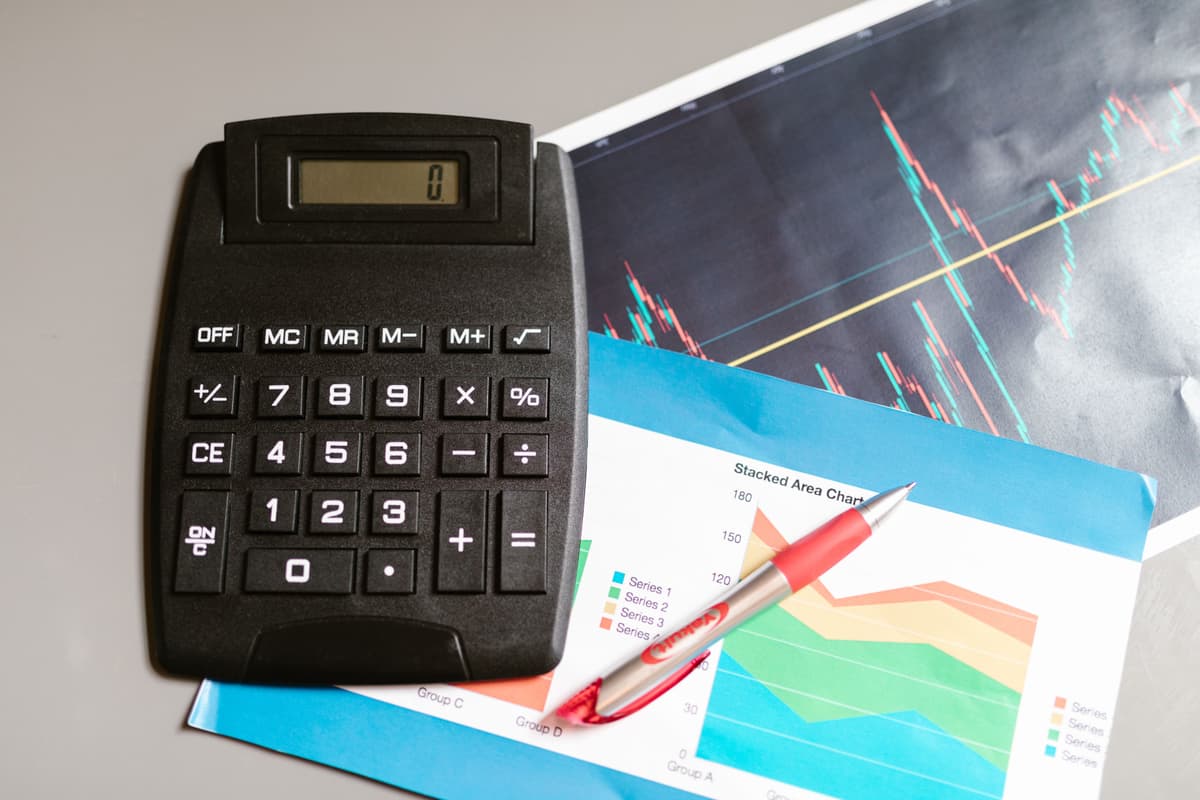 Close-up of a calculator and a pen