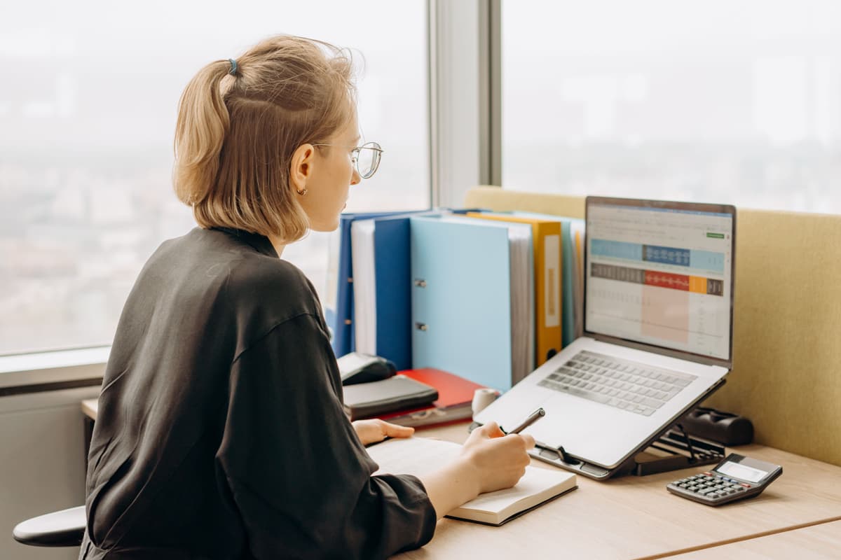 Close-up of a person checking numbers on a spreadsheet